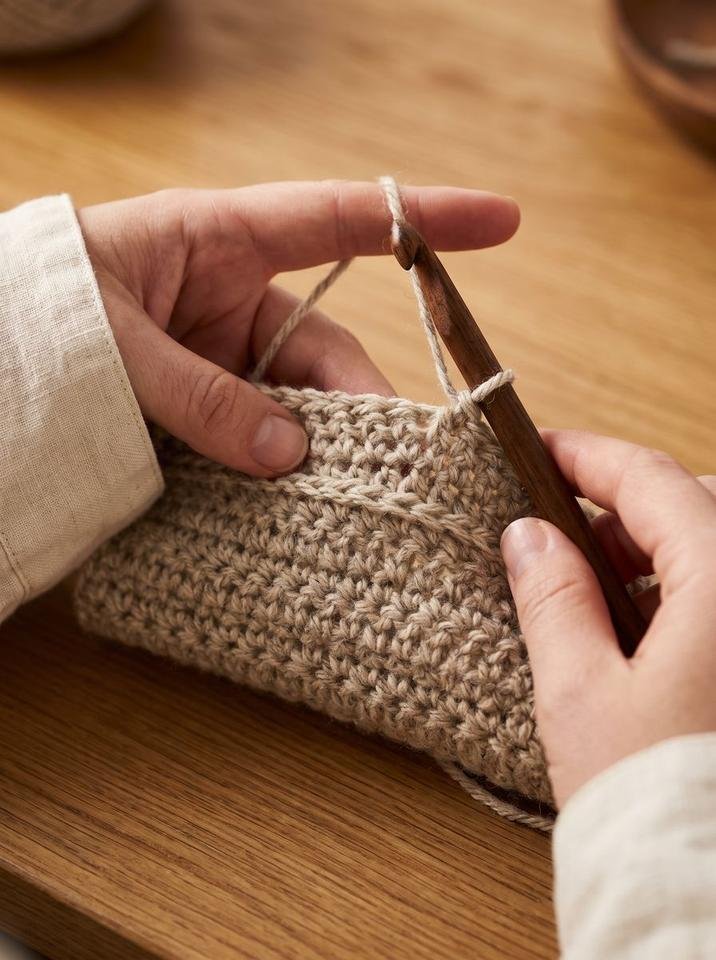 Reverse herringbone single crochet technique showing hook insertion from back to front